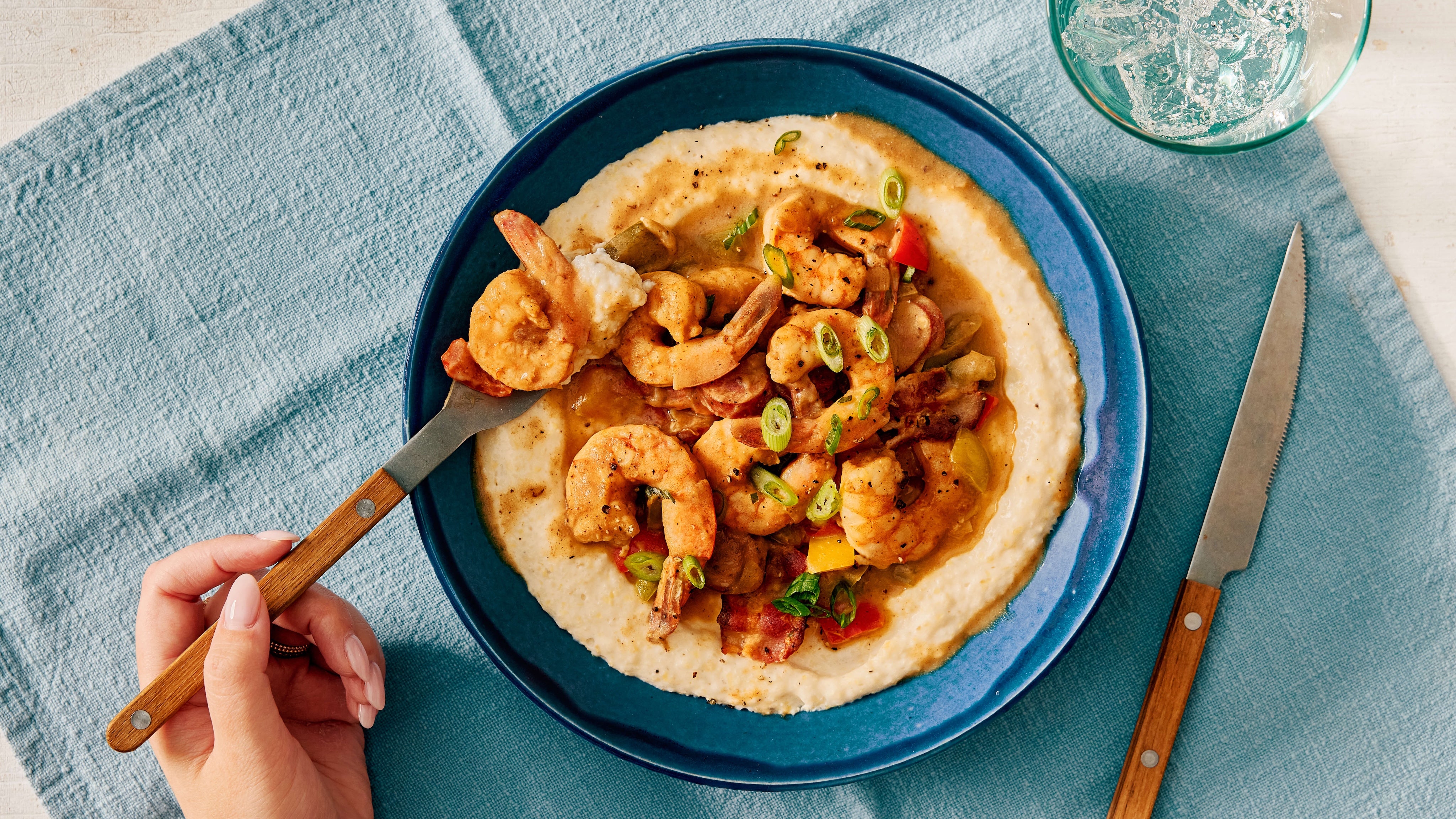 Shrimp and gritzy grits topped with andouille sausage and scallions