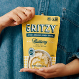 Person holding a pouch of Gritzy Buttery Ready Grits