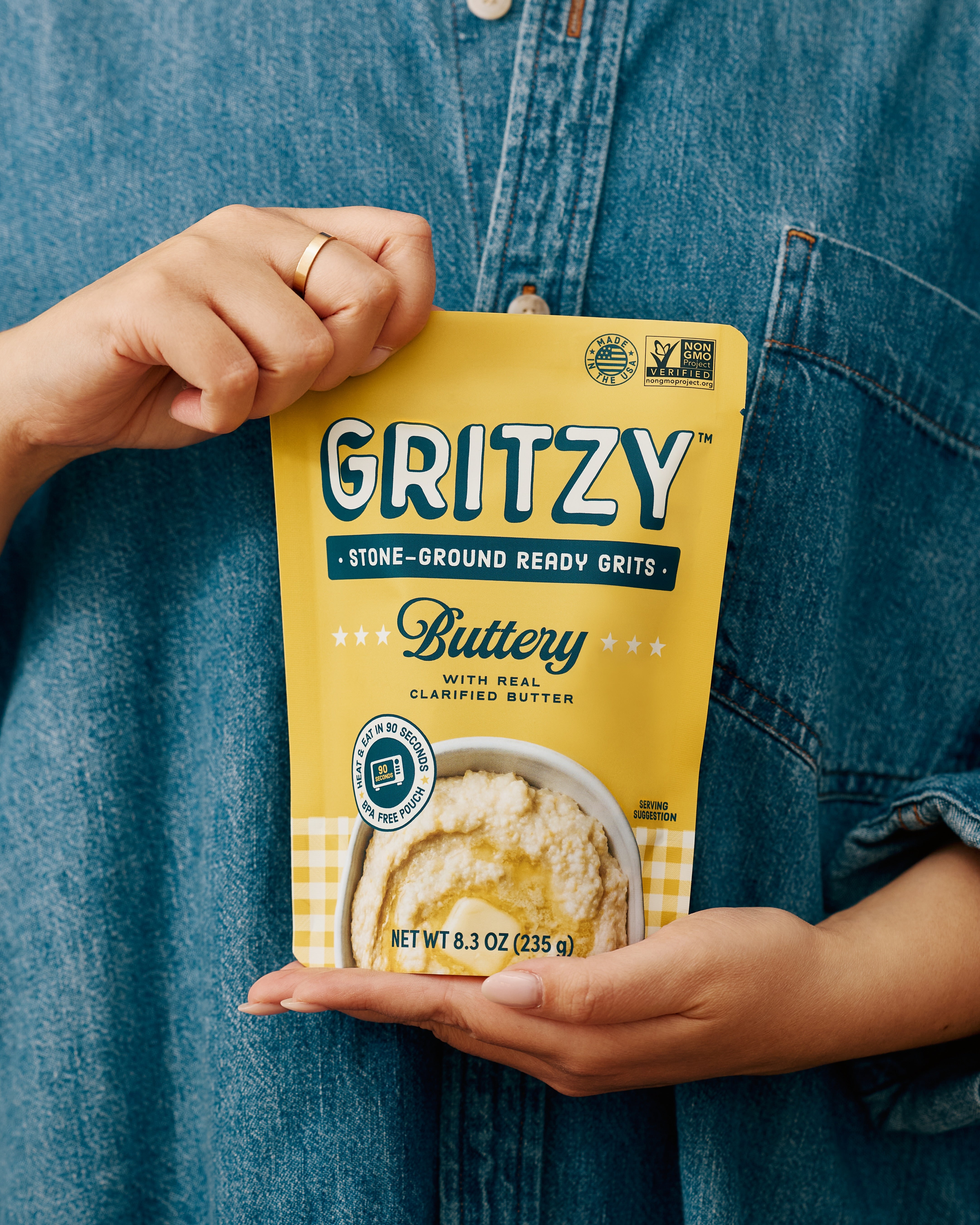 Person holding a pouch of Gritzy Buttery Ready Grits