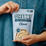 Person holding a pouch of Gritzy Classic Ready Grits