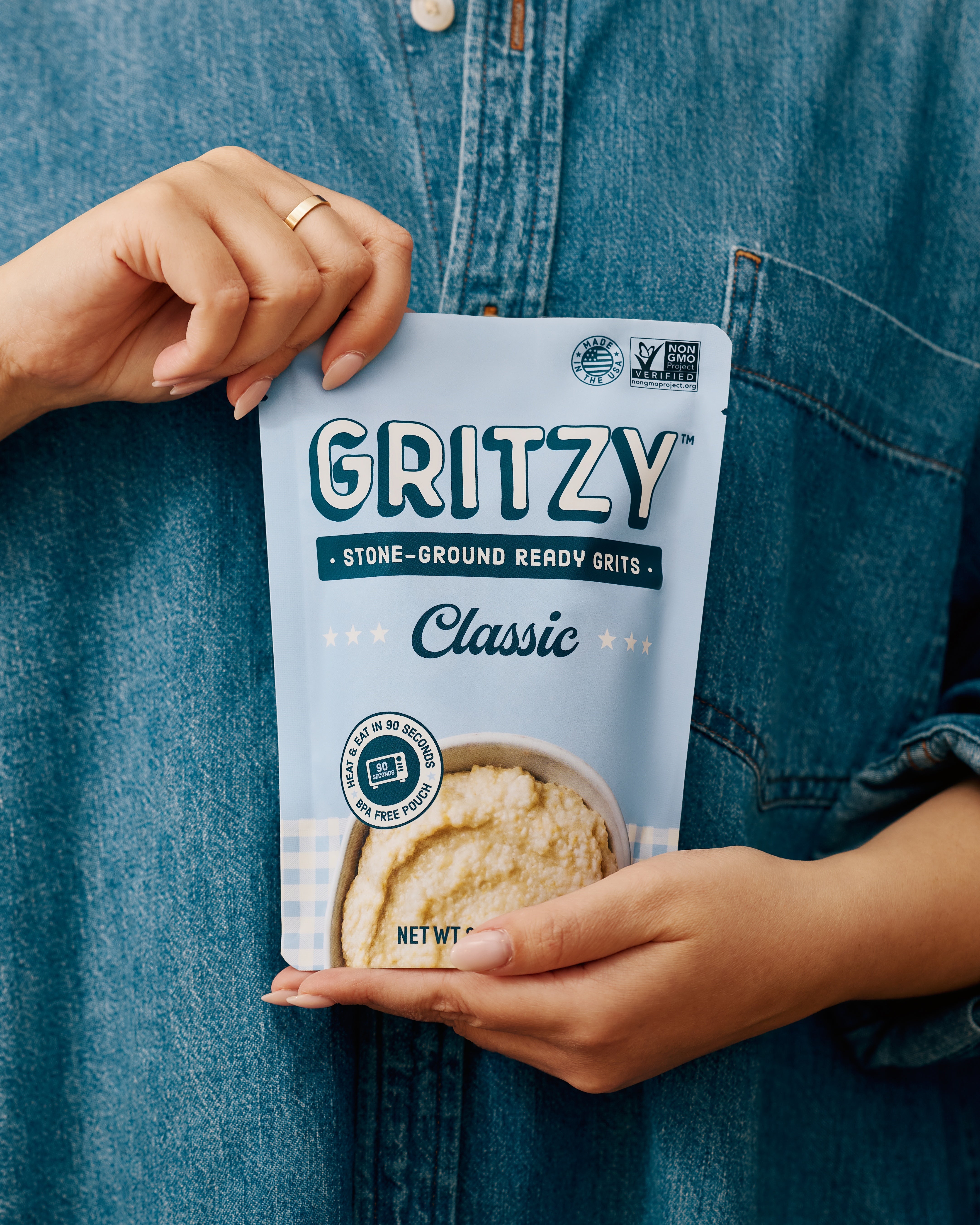 Person holding a pouch of Gritzy Classic Ready Grits